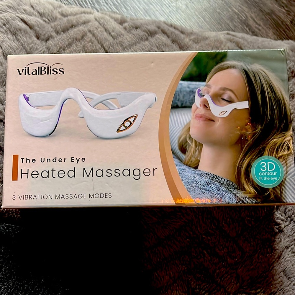 Heated under eye massager